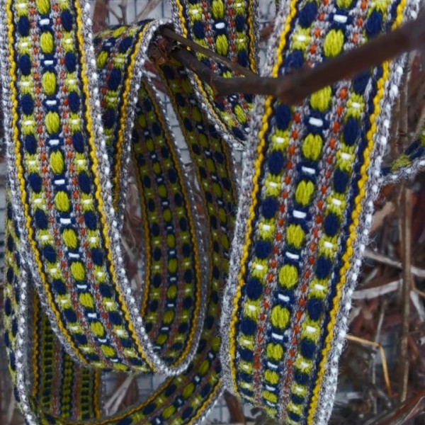 Austa Rencēnu tautiskā ziedainā josta zaļā, rūsas, baltā  zilā un pelēkā krāsā.